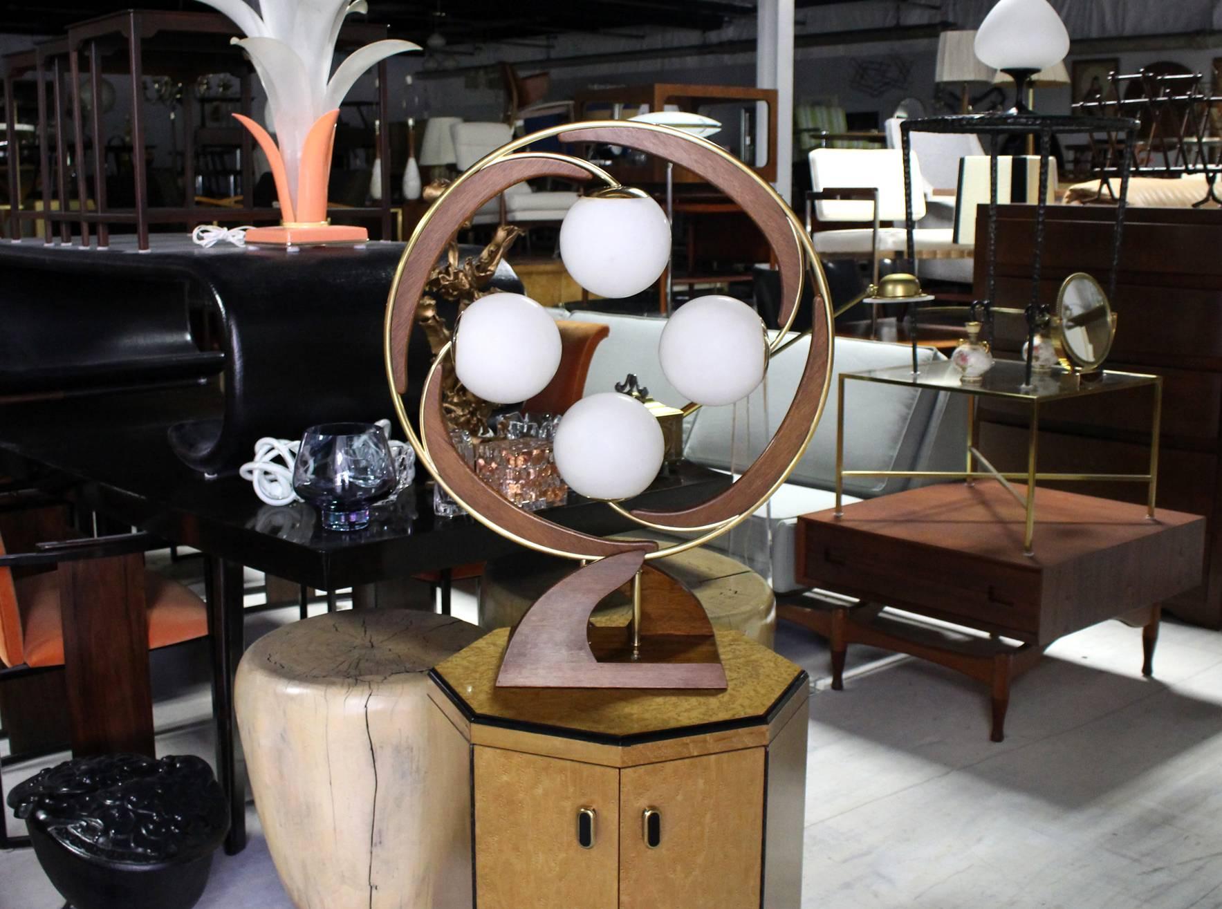 Mid-Century Modern walnut and brass four glass globe shades table lamp.