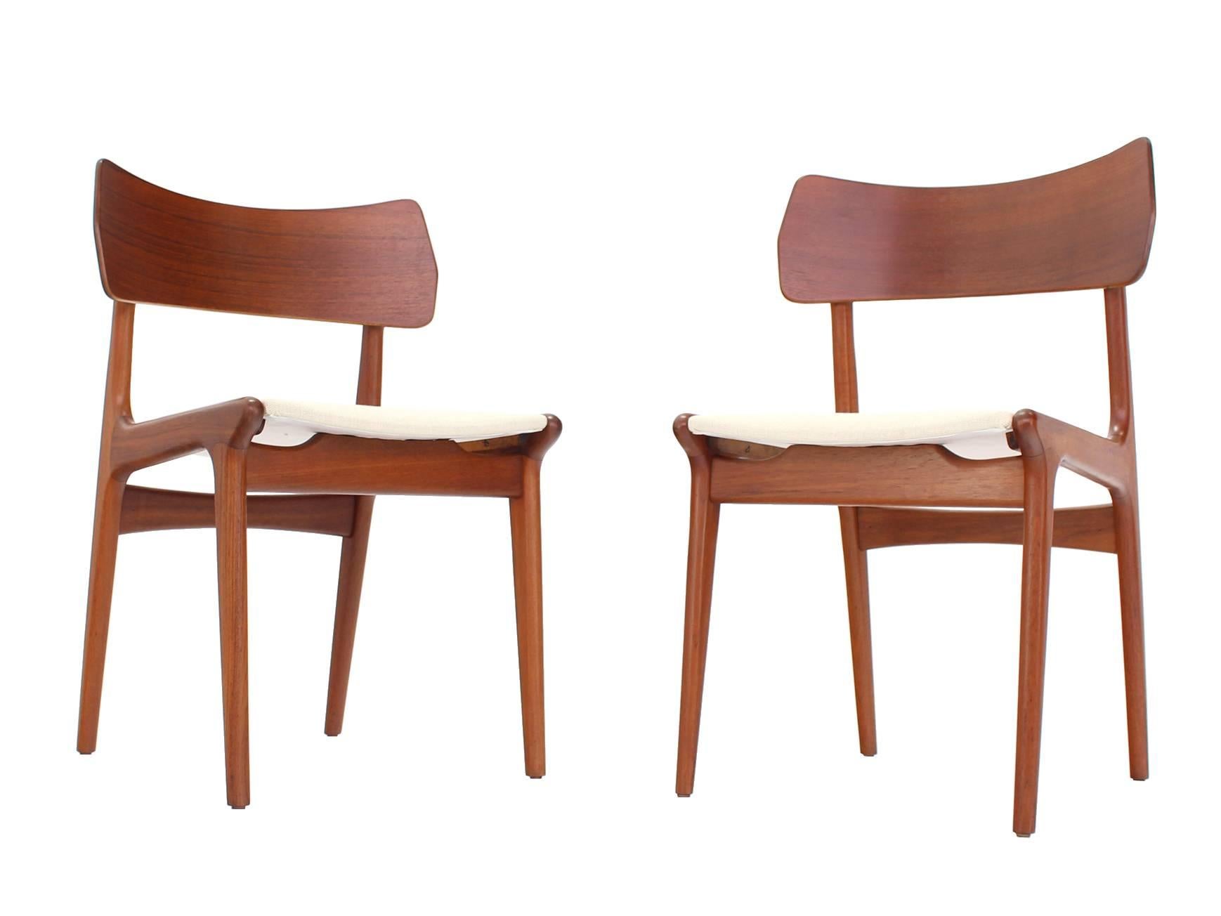 Set of four Danish modern wide backs side chairs with new upholstery.