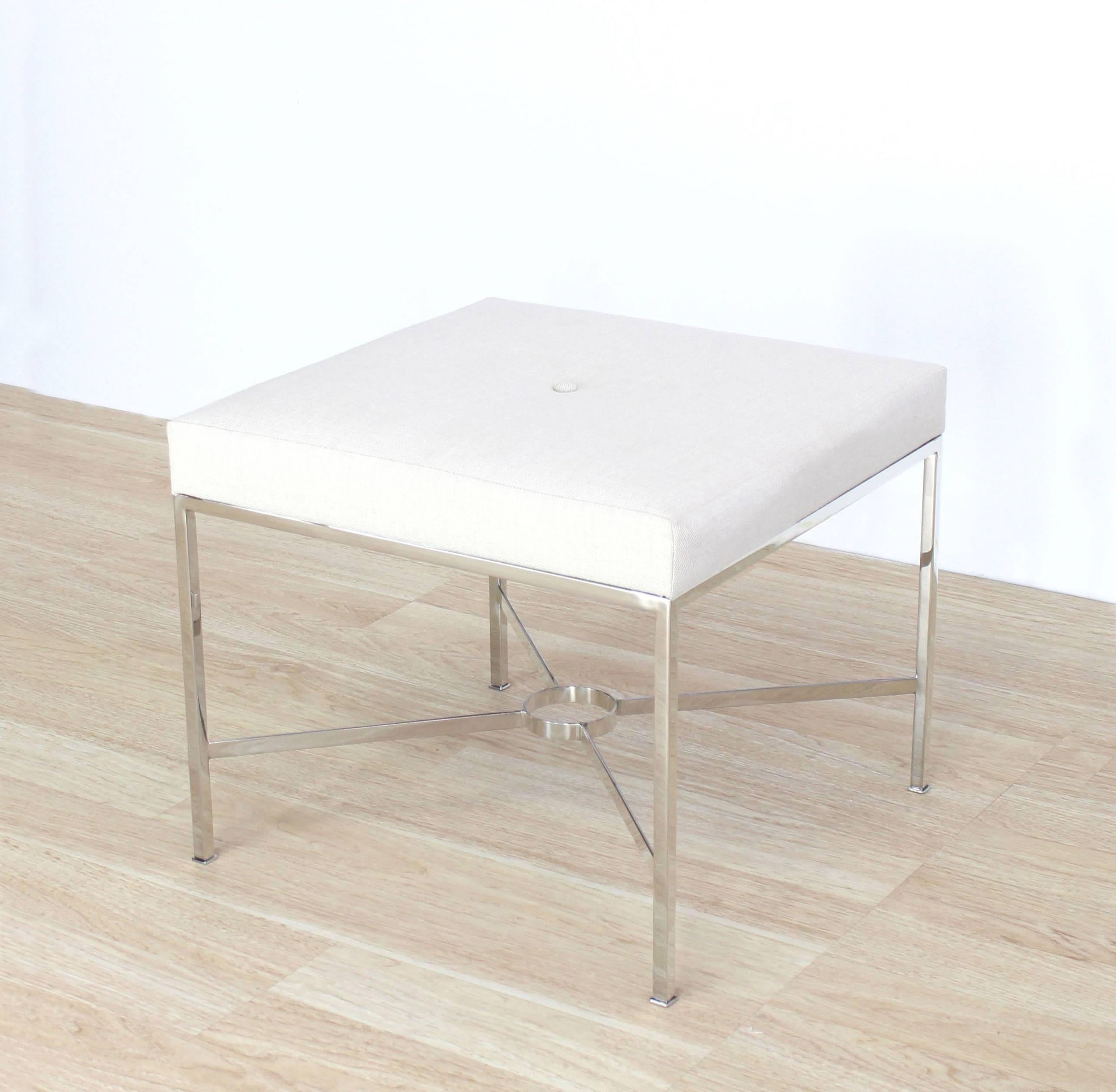 Stainless steel X base bench with fabric upholstery.