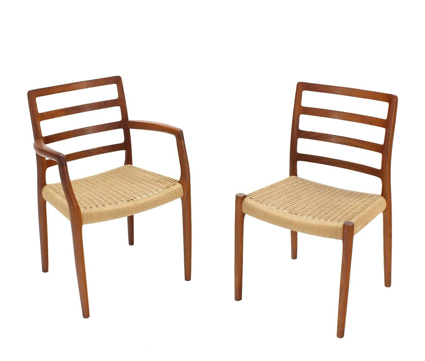 Nice rush seats and excellent condition set of four Danish modern teak dining chairs.