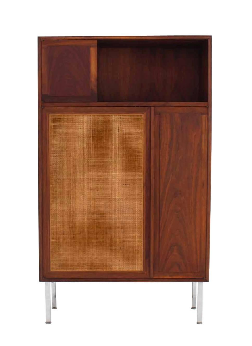 Nice Mid-Century Modern walnut cabinet with caned door.