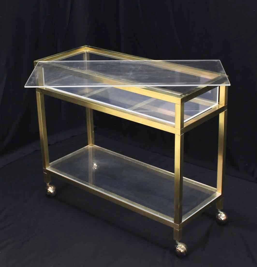 Very nice Mid-Century Modern rectangular brass and Lucite cart with showcase compartment.