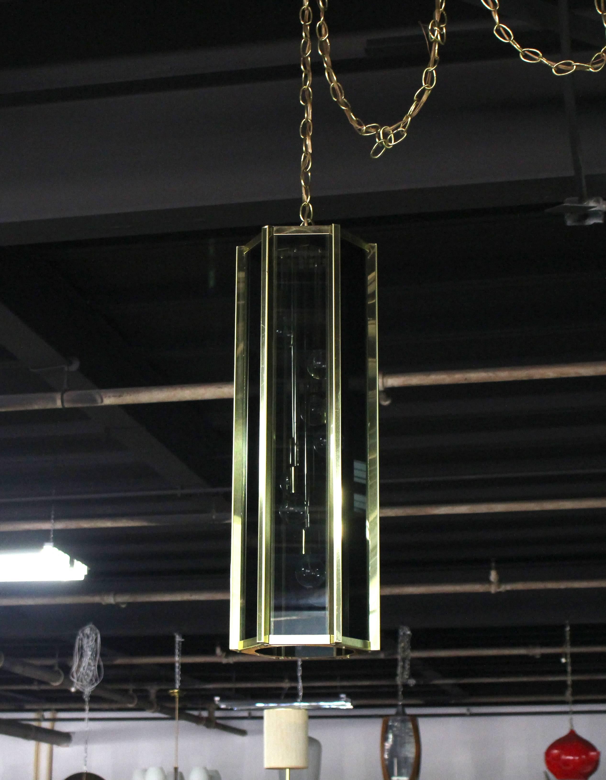 Mid-Century Modern Tall and Narrow Smoked Glass and Brass Pendant Light Fixture For Sale