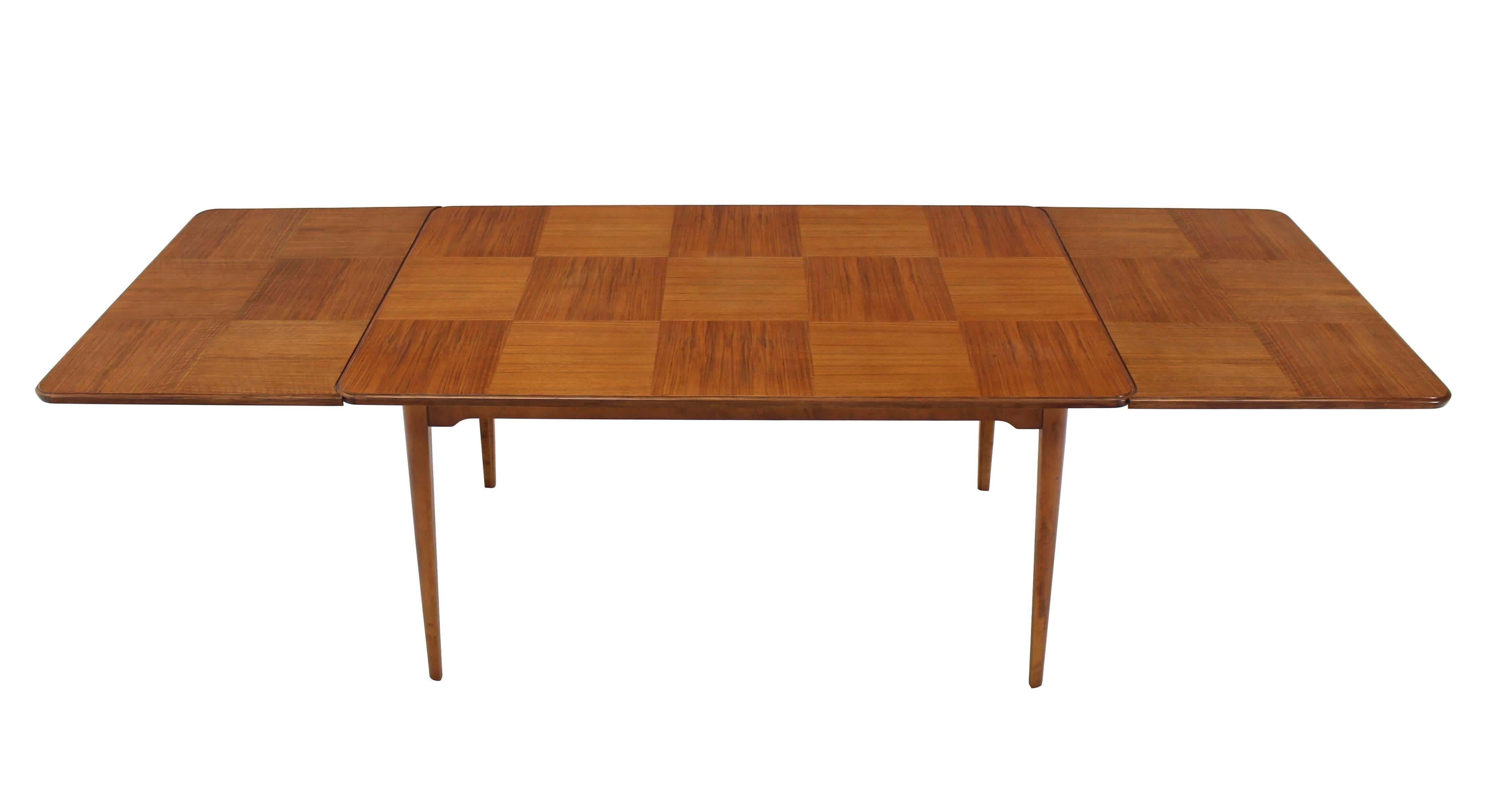 Very nice Mid-Century Swedish modern dining table by Edmond Spence. Two 2 x 24" extension leaves.