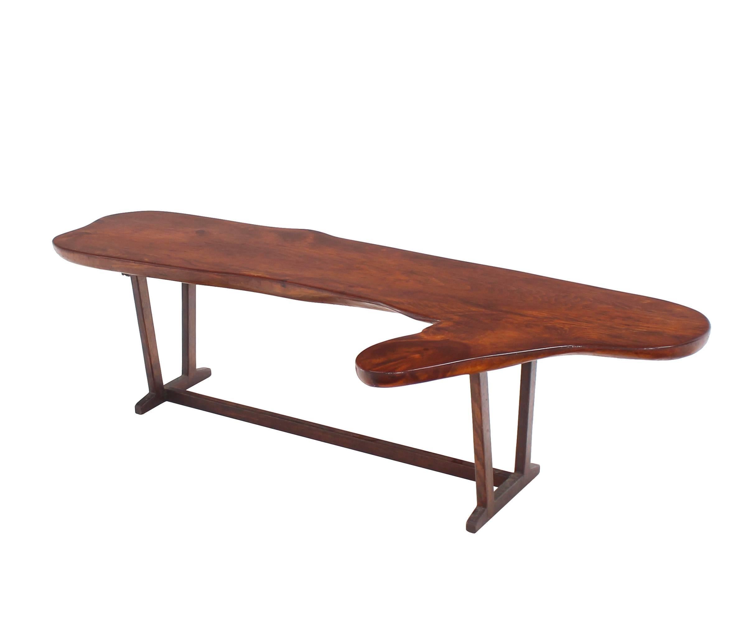 Very nicely built organic shape coffee table or bench. Nice thick solid wood top.