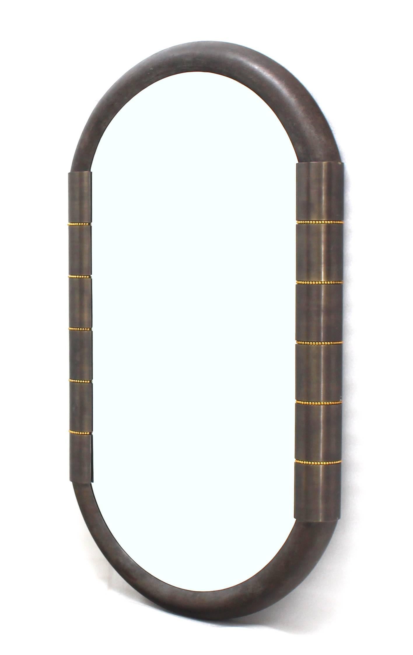 Forged metal Mid Century Modern racetrack shape metal and bronze frame mirror.