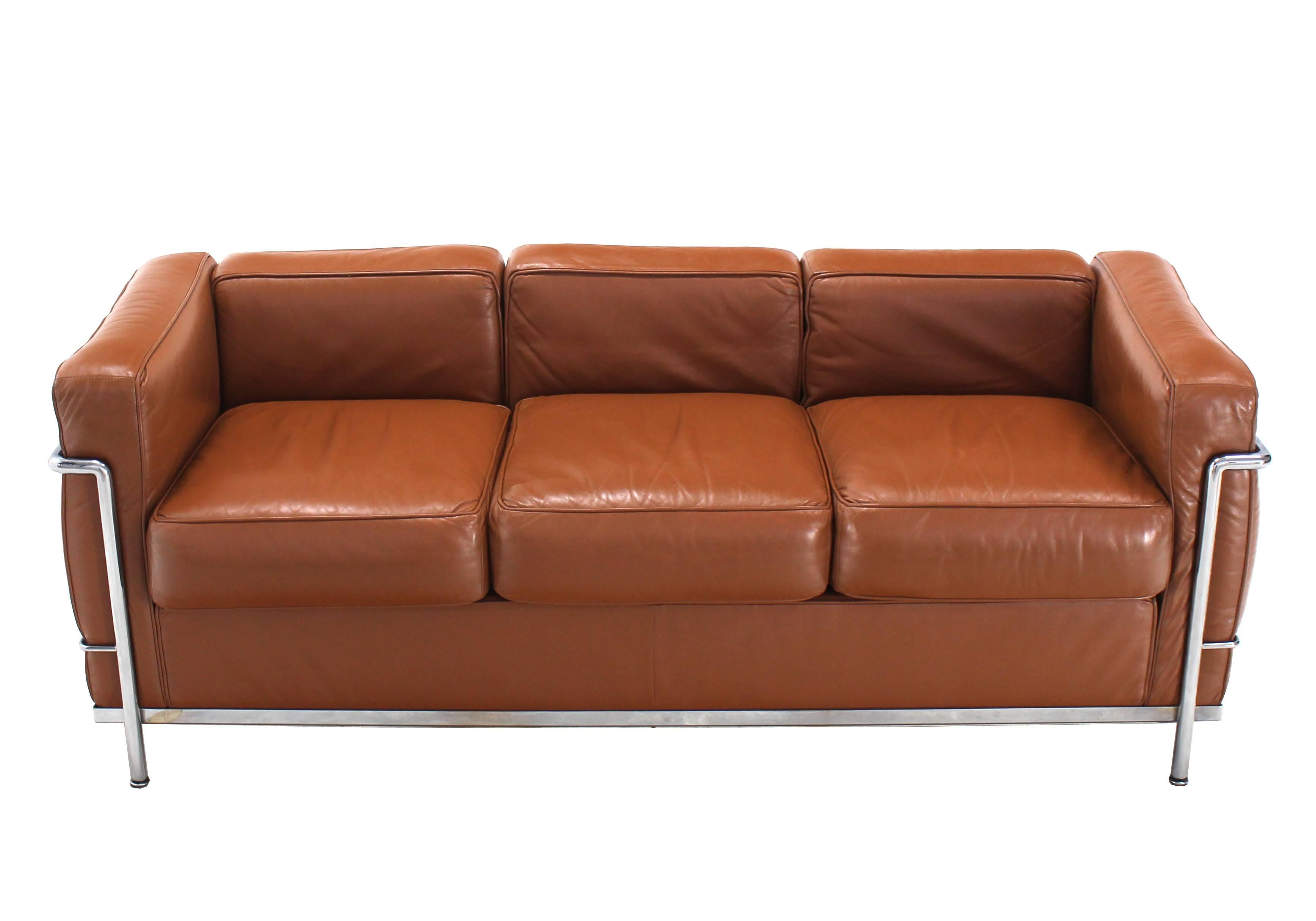 Authentic Cassina LC2 three-seat sofa in beautiful brown leather numbered and stamped in excellent vintage condition. We have matching chairs listed separately.