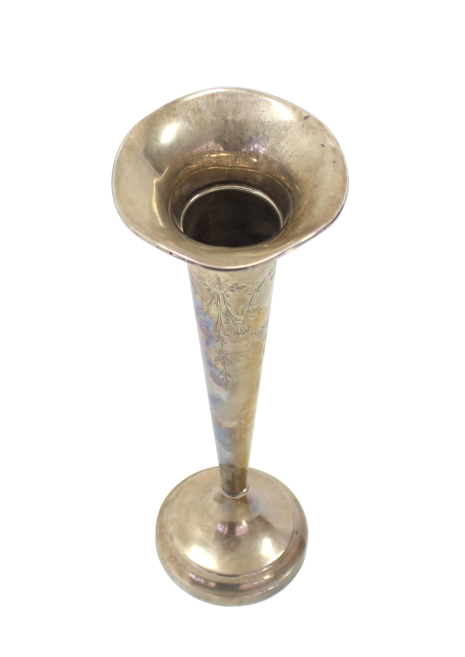 Narrow standing elegant and tall sterling silver vase with flower pattern etching.