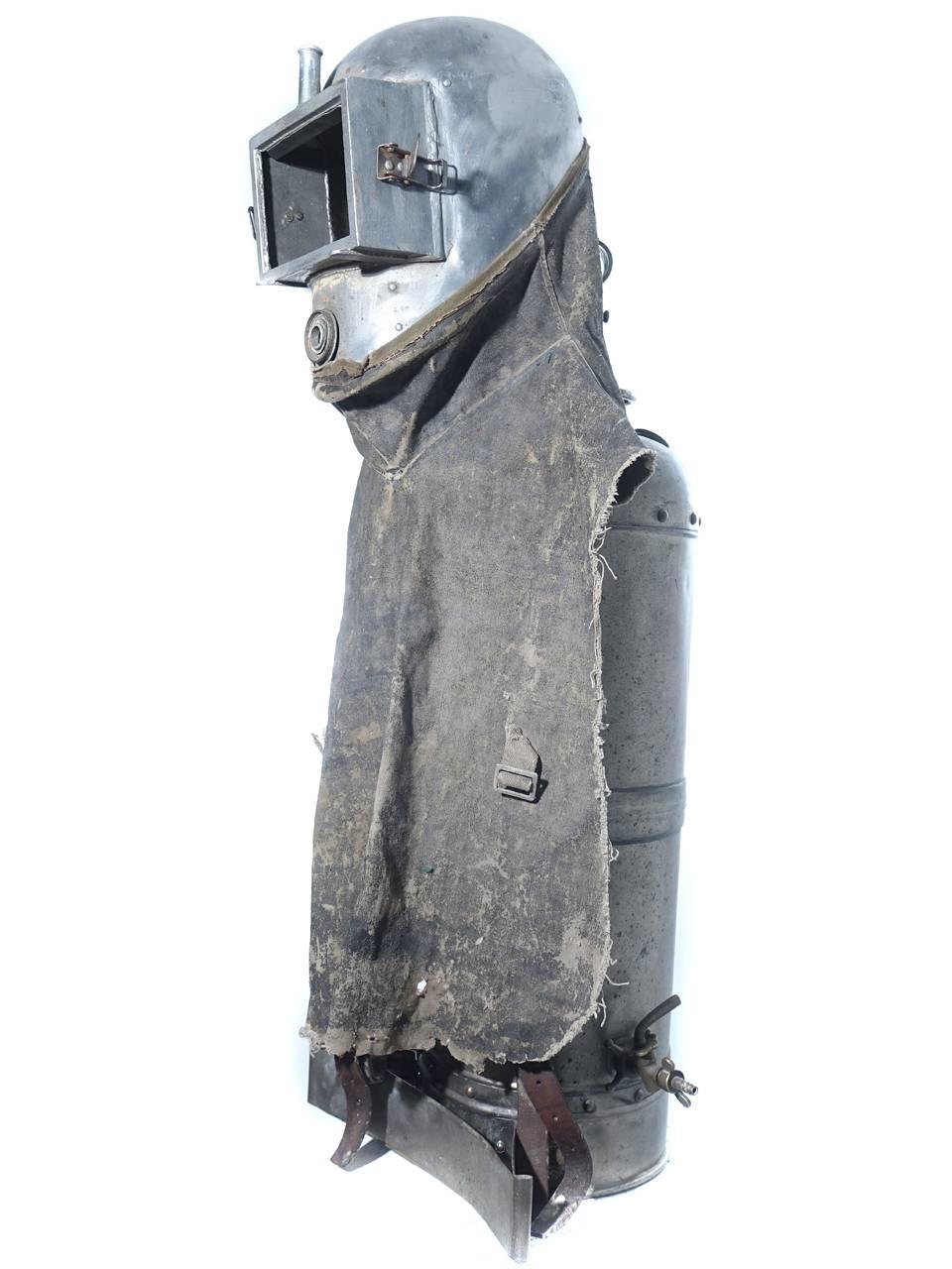 This Industrial outfit has a striking tribeI and sculptural presence. It displays well on its handmade museum quality stand. I almost never sell items from my museum collection. Here is your opportunity to get your hands on one of the more