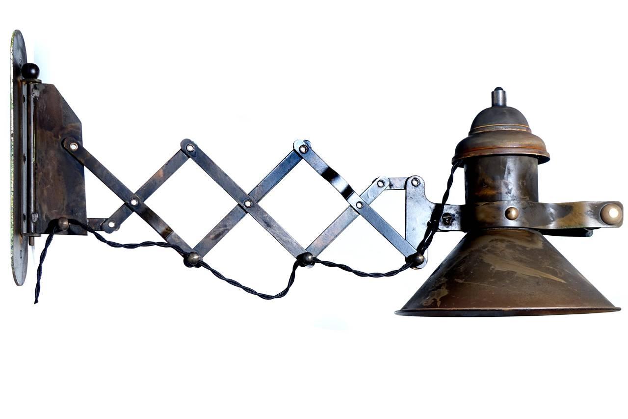 This is a nice Industrial quality scissor wall sconce. The heavy shade has the look of a gas lamp and the handle is solid turned brass. We have never offered one like this before.