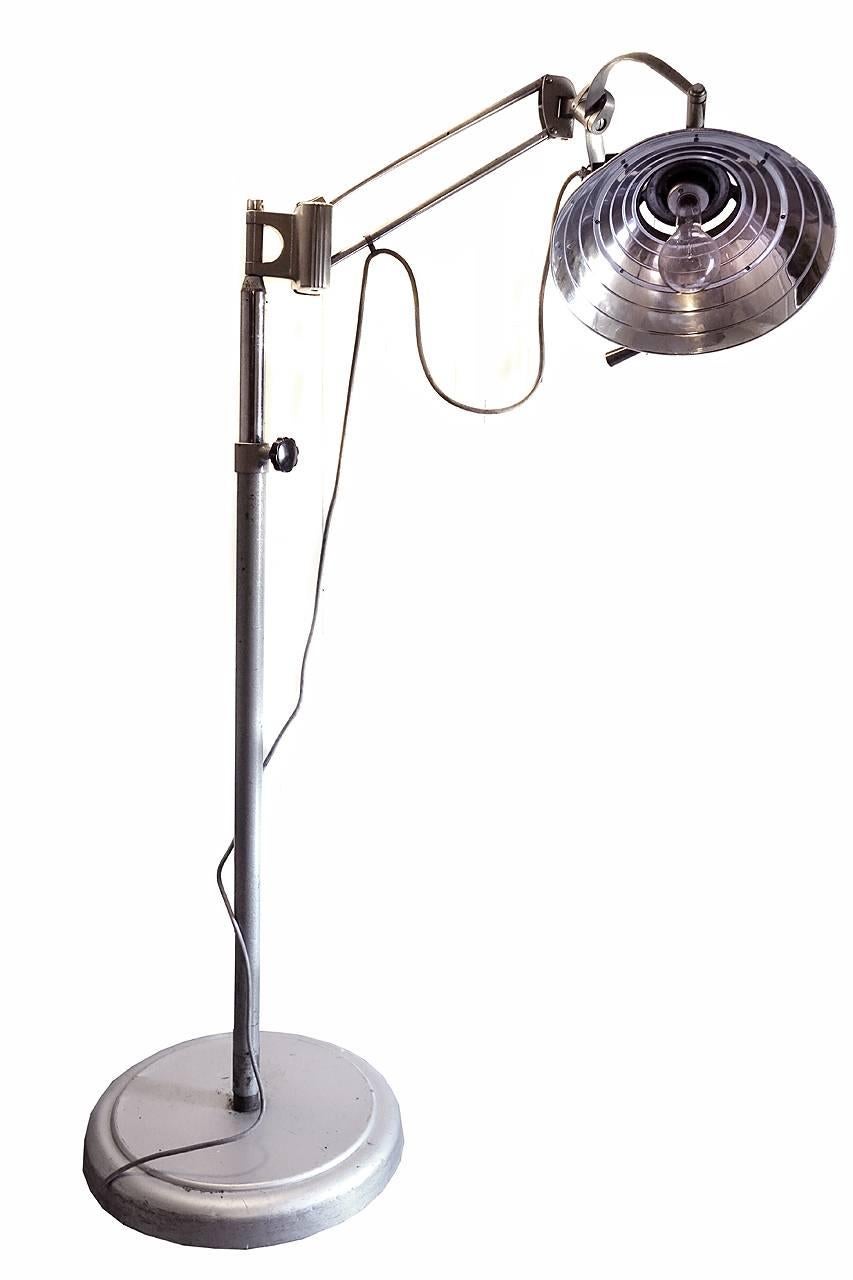 This is a solid floor standing medical exam light. The articulating arm and telescoping pole make this one of the easiest to adjust and position. For 20 years I used this as a photography lamp for my table top work… I can pull the lamp head right