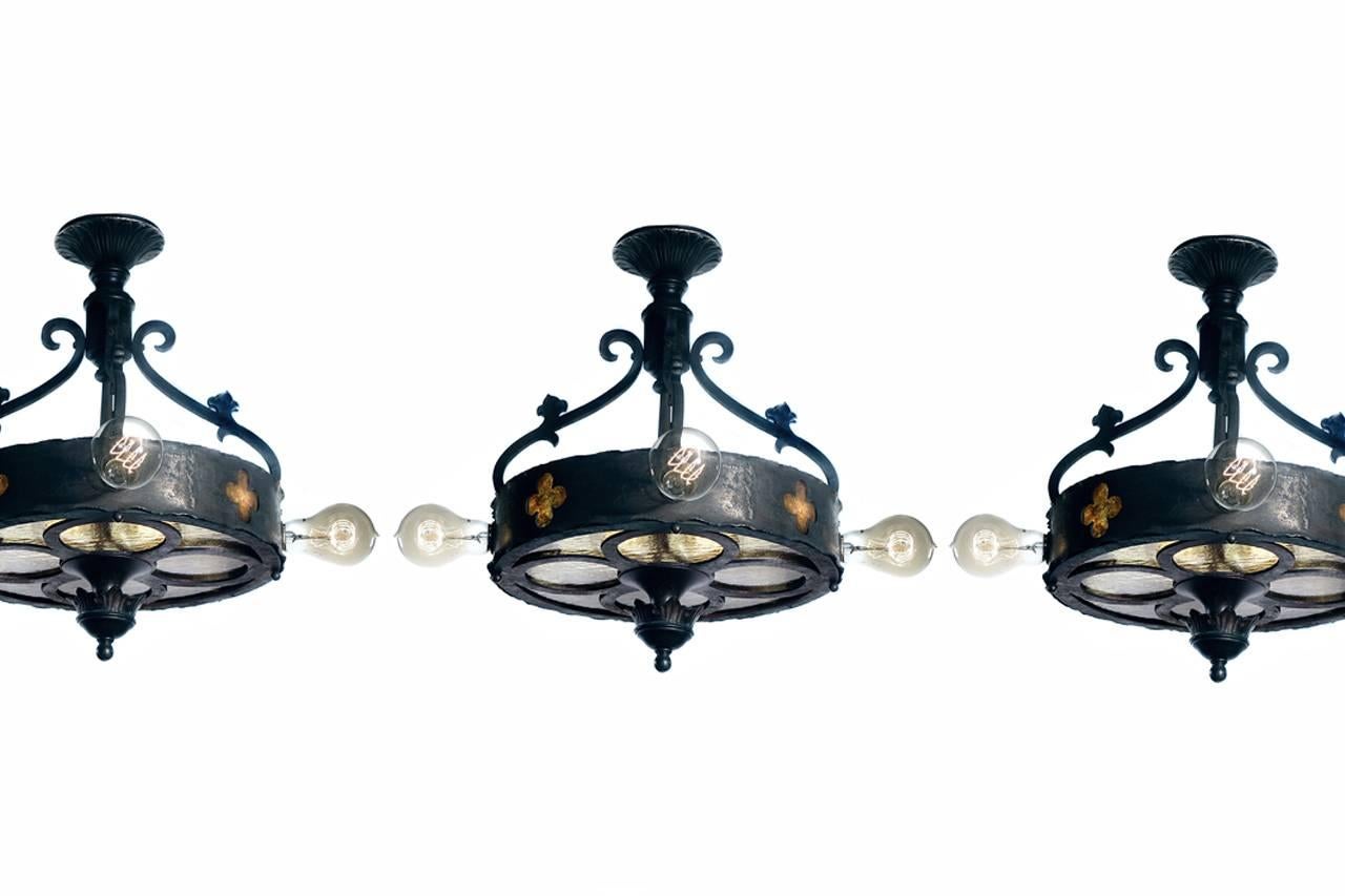 We have three matching lamps in stock. They are priced per… you can buy only one or the collection. 
This is an interesting set of small and early theater chandeliers. Each has four bulbs set horizontally around the outside edge in marquee fashion