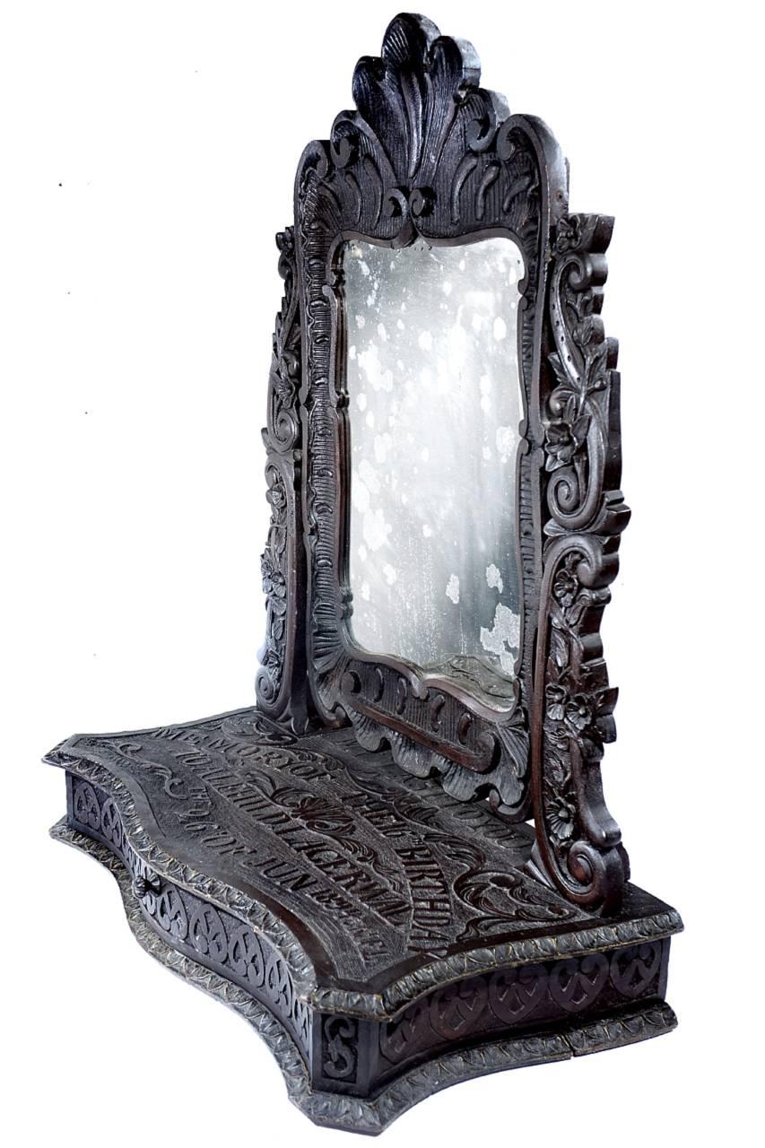 This is a unique, elaborate and highly detailed object. Its a one of a kind table top draw and mirror. It was lovingly carved in oak, signed and dated as a family gift. It reads… My last to you. Memory of the 16th birthday. To Alfhild Lagerwal, the