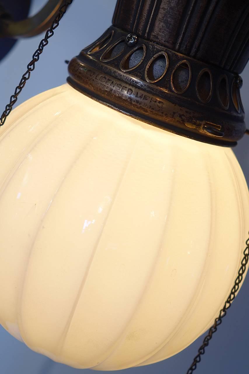 These sconces have a unique look and the proportions perfect. All the ornate metal parts are antique brass and the ribbed globes have a 6 inch diameter. We converted the lamp to electric using a standard bulb. All the original gas valves and chains