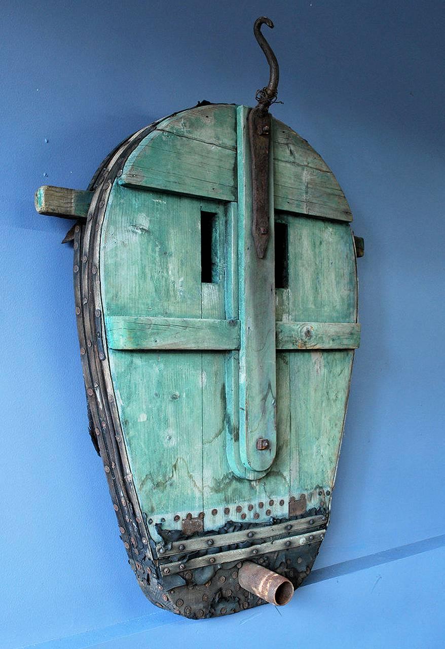 This striking object dates from the turn of the century with details like berry dyed stain, aged leather and hand wrought hardware. This piece has a nice way of transcending its intended use and becoming a very graphic mask like sculptural object