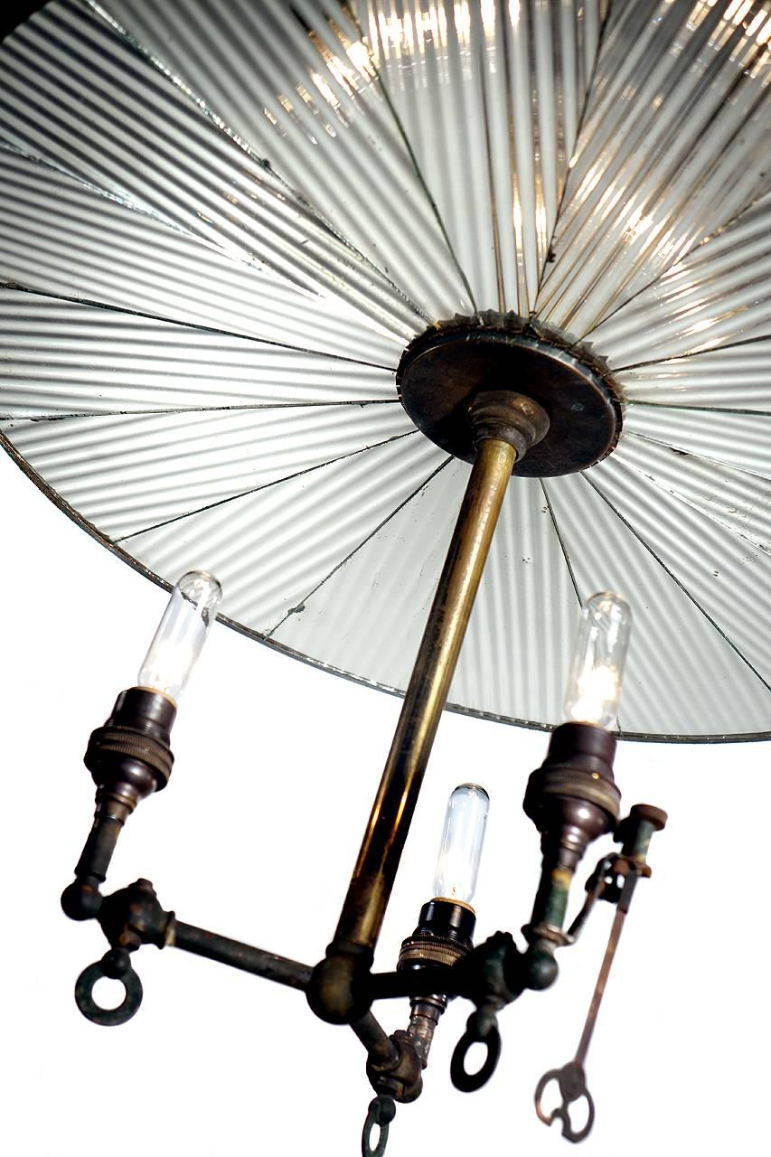 This is a large and very rare 1800s signed Frink lamp. The flat circular reflector has a 20 inch diameter and 16 pie shaped mirrors. The three original gas jets were wired to take a standard candelabra bulb. Note that one of the jets still has the