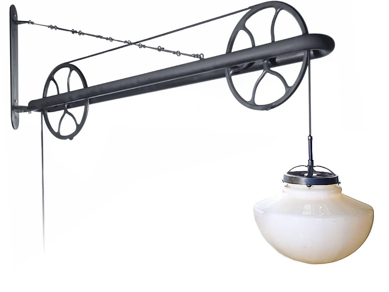 This is an impressive lamp and the proportions are dramatic. This large pulley lamp extends over 70 inches. The wall bracket is 22 inches. It easily swings in a full arc from left to right. The striking 1920s 15 inch diameter milk glass shade has a