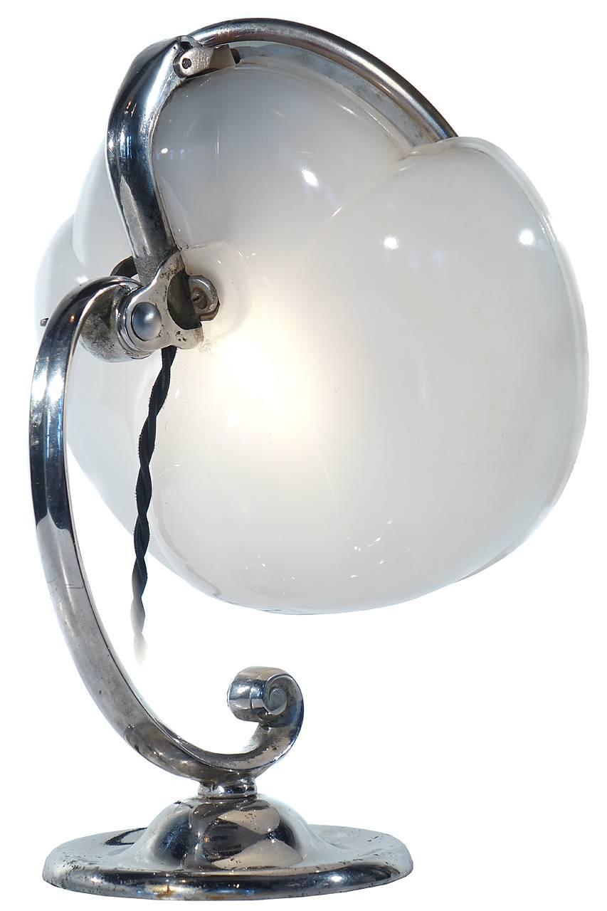 This is a rare Lapeer, model 100 make up mirror lamp. They sometimes call the a cloud lamp. The round articulated mirror sits against a milk glass lamp reflector. It gives off a perfect shadowless and even light. Its a perfect bathroom or bedroom