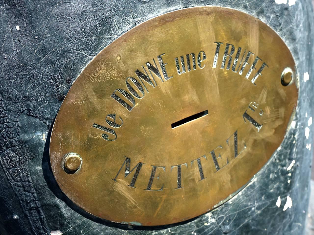 This five foot plus papier mâché pig was used as a fund raiser or trade stimulator. The brass stomach plaque has a coin slot and reads in French... Put 1 Franc - I give one Truffle. Inside the pig is a shoot that takes the coin to a paper cache