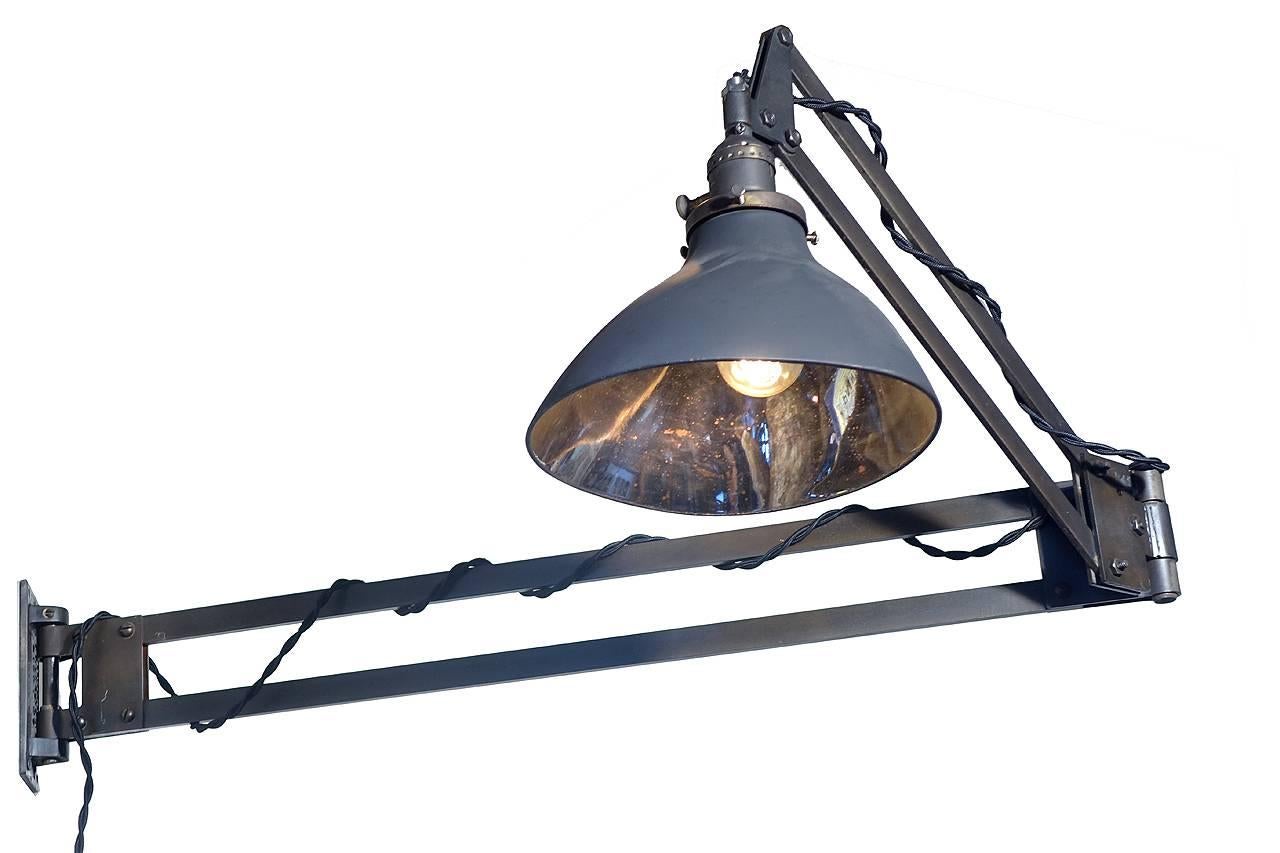 These Burton Light Company lamps are a rare find. They reach out 44 inches and with matching mercury glass shades. The shades are by the X-Ray Lamp Company. The shade is mirrored with a matte black pebbled original finish outside. The patented