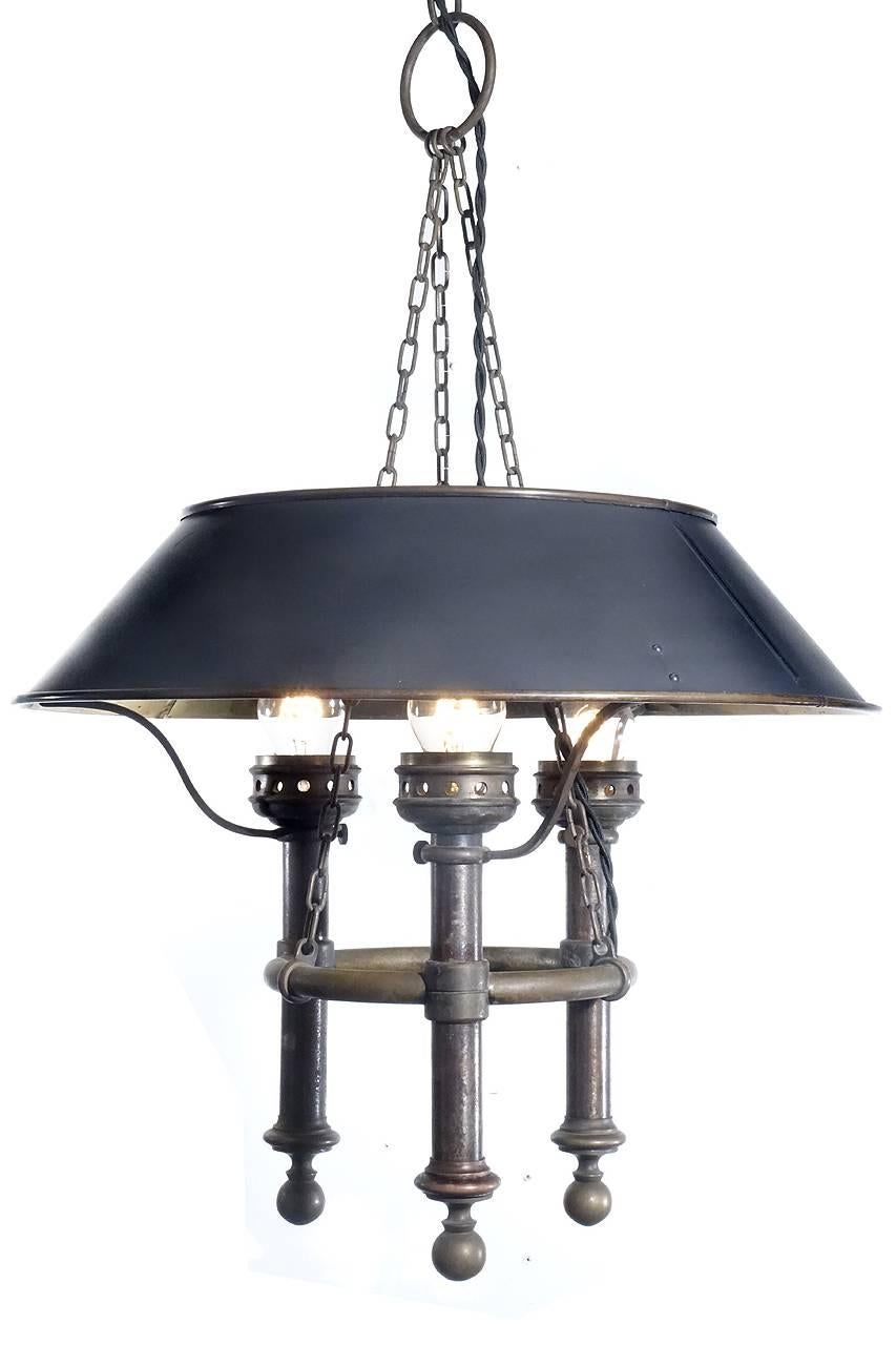 This is a very elegant early lamp. The 18 inch donut shade polished reflective brass interior. Its 36 inches tall including the chain and ring.