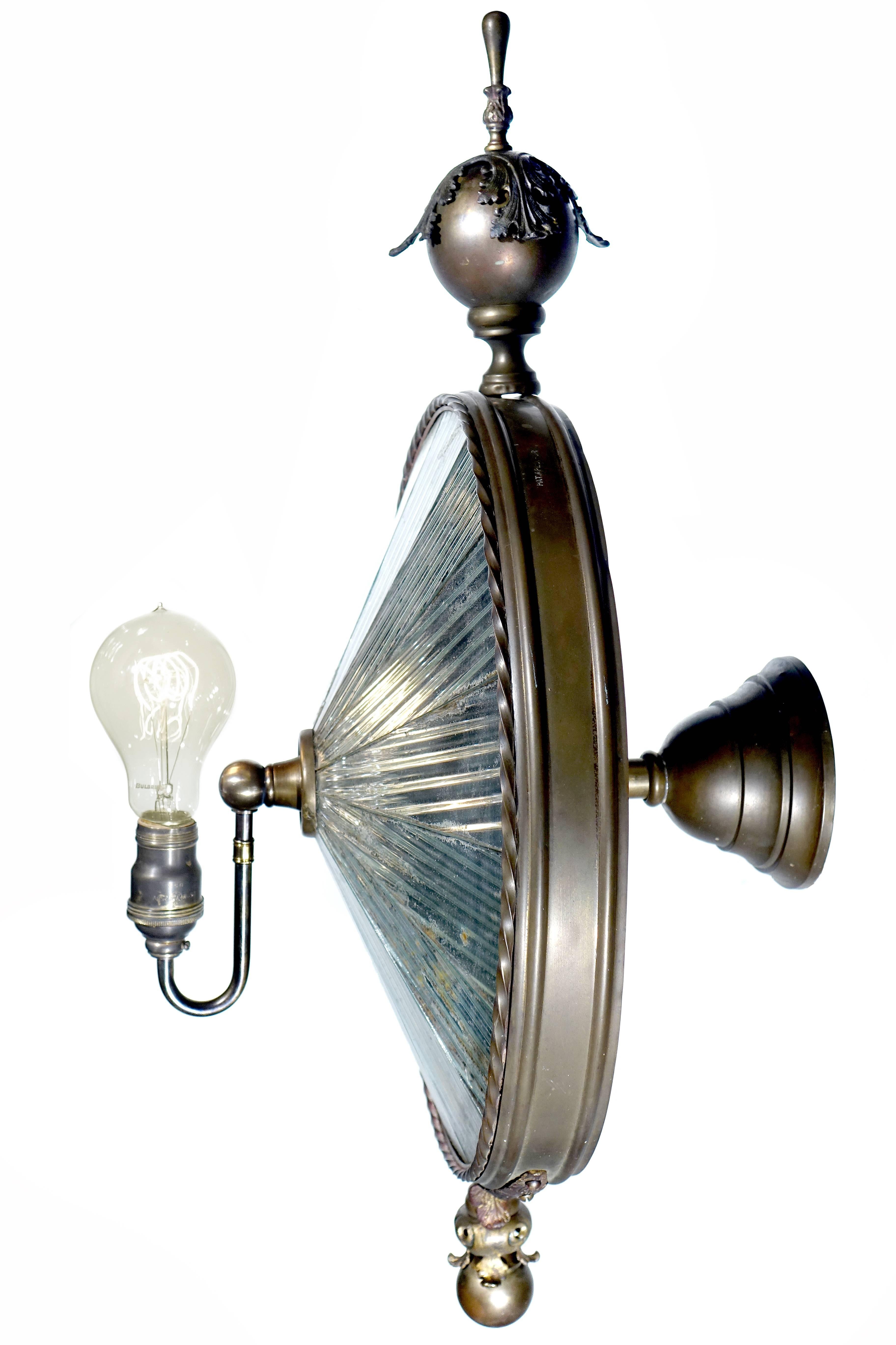 This one is a first for us and very unique. This sconce has 16 original fluted mirror panels. The look is just right. It looks early and may have originally been a gas fixture. It now take a single standard bulb. The top and bottom finials plus the