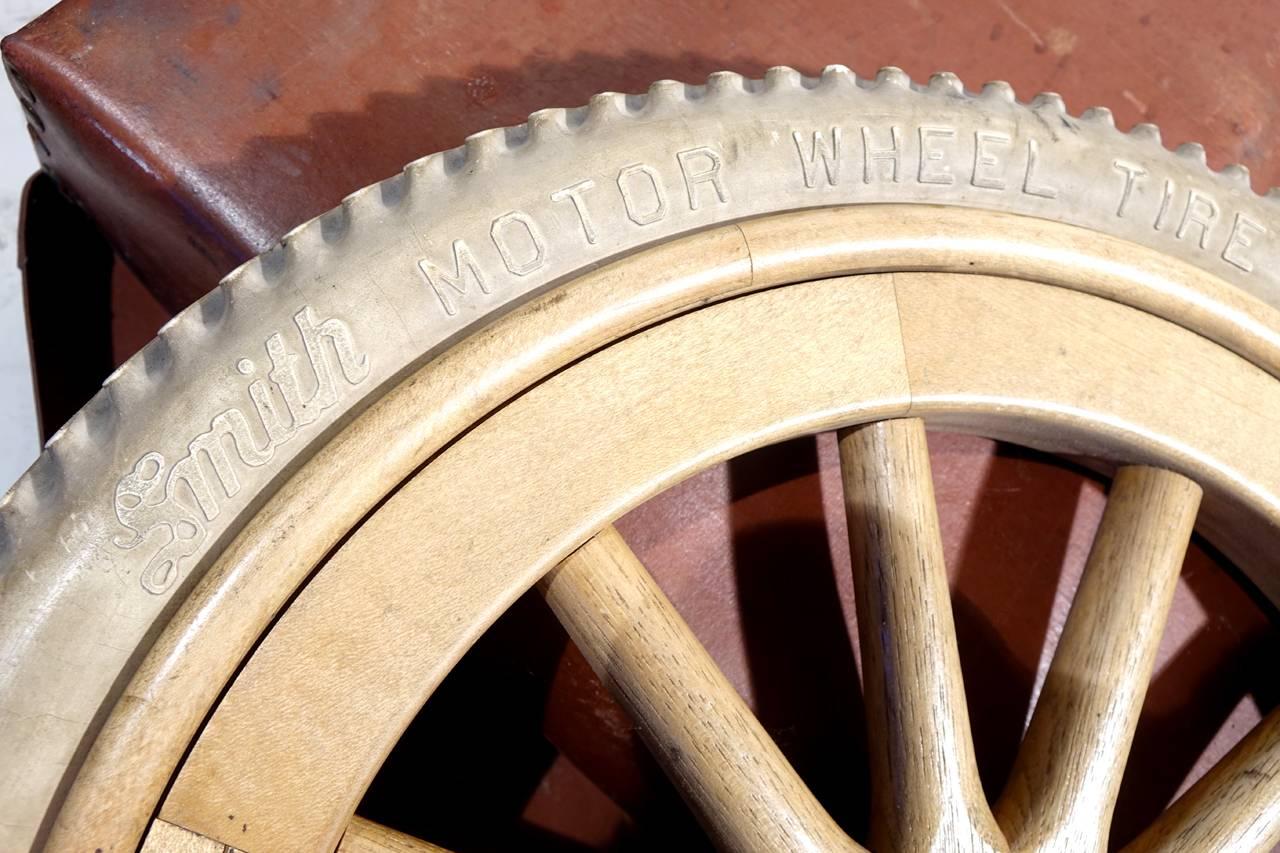 This is a 20 inch artillery style wheel and tire signed by Smith Motor Wheel Co.
It still sits in the original leather strap carrying case.