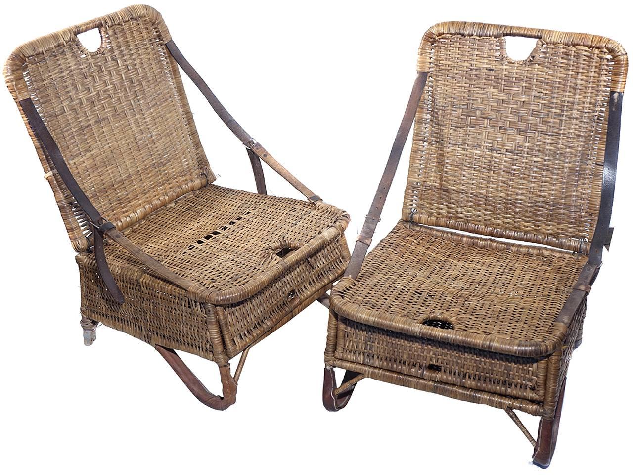 This is an early matching pair of canoe seats. The original owners used there for the beach and picnics. I'm guessing they are 1920s from the style and leather straps. Each fold up like a carrying case. The front has a door that opens for storage.