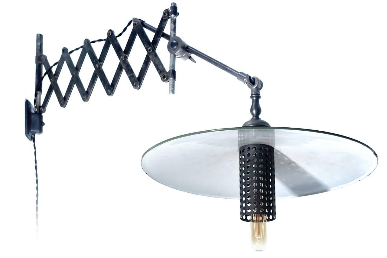 This lamp has a unique look. The antique green over white porcelain shade has a 16 inch diameter and sit on a brass articulated rod. With the rod and scissor this will extend to almost 4 foot.