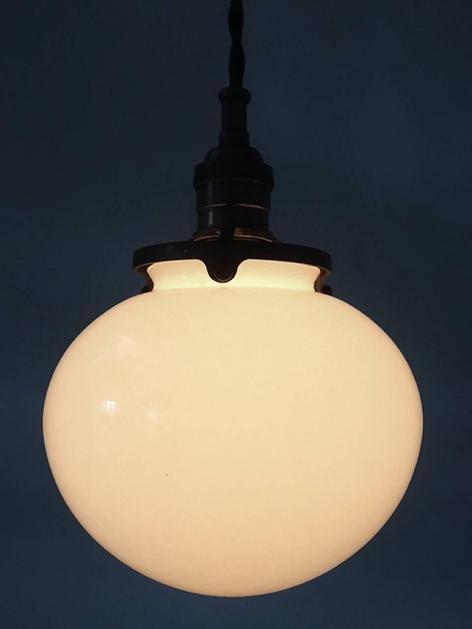 The glass on these globes are simple and very elegant. They are sandwich glass with an outer layer of Vaseline over milk glass. It has a nice warm glow and the milk glass helps spread the light evenly with no glare. There is a full moon look to the