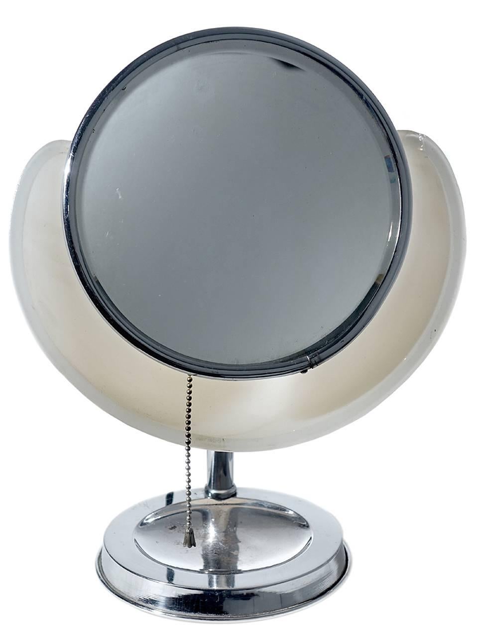 This is a rare Lapeer, model 100 make up mirror lamp. They sometimes call the cloud lamp. The round articulated mirror sits against a milk glass lamp reflector. It gives off a perfect shadow less and even light. It’s a perfect bathroom or bedroom