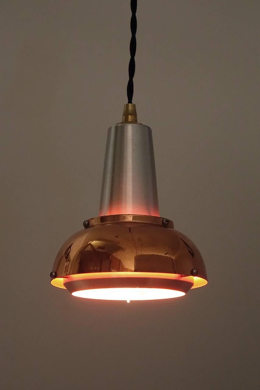 I am guessing that these pendants date to the early 1960s. Aside from the period design and beautiful condition the small size is what makes them so unique. I love the combination of copper, aluminum and the orange painted interior together. It also