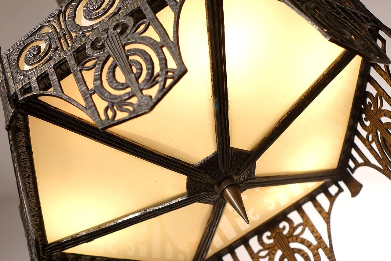 This beautiful French Deco lamp is untouched and all original. It's in the style of Edgar Brandt or Paul Kiss. The lamp and top finial  has a wonderful skyscraper design. All we did was rewire the sockets. The glass and metal finish are as they were