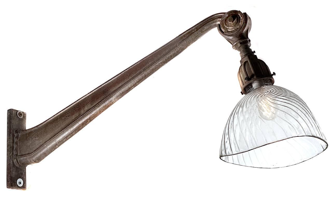 These French arms are beautiful cast iron with an original patina. The end of the arm has an angle adjustment to point the lamp and shade. The look is very clean and a bit Art Deco. The shade is one of the largest mercury glass examples that was