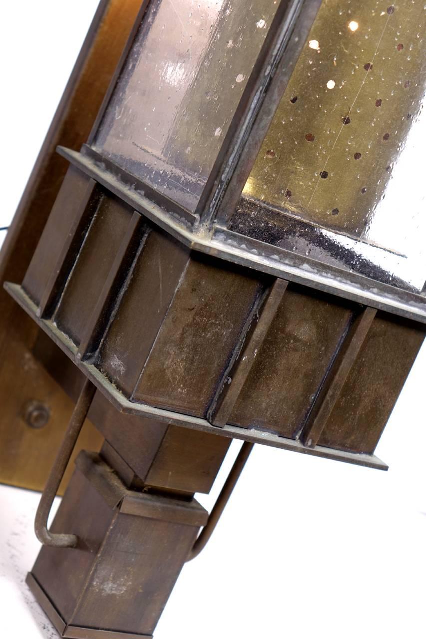 Here is a matching pair of Arts & Crafts copper sconces. I am guessing that they are handmade and mid-20th century. There is a strong Frank Lloyd Wright look to them. Each is over two foot tall and has the original patina. On display at our 115