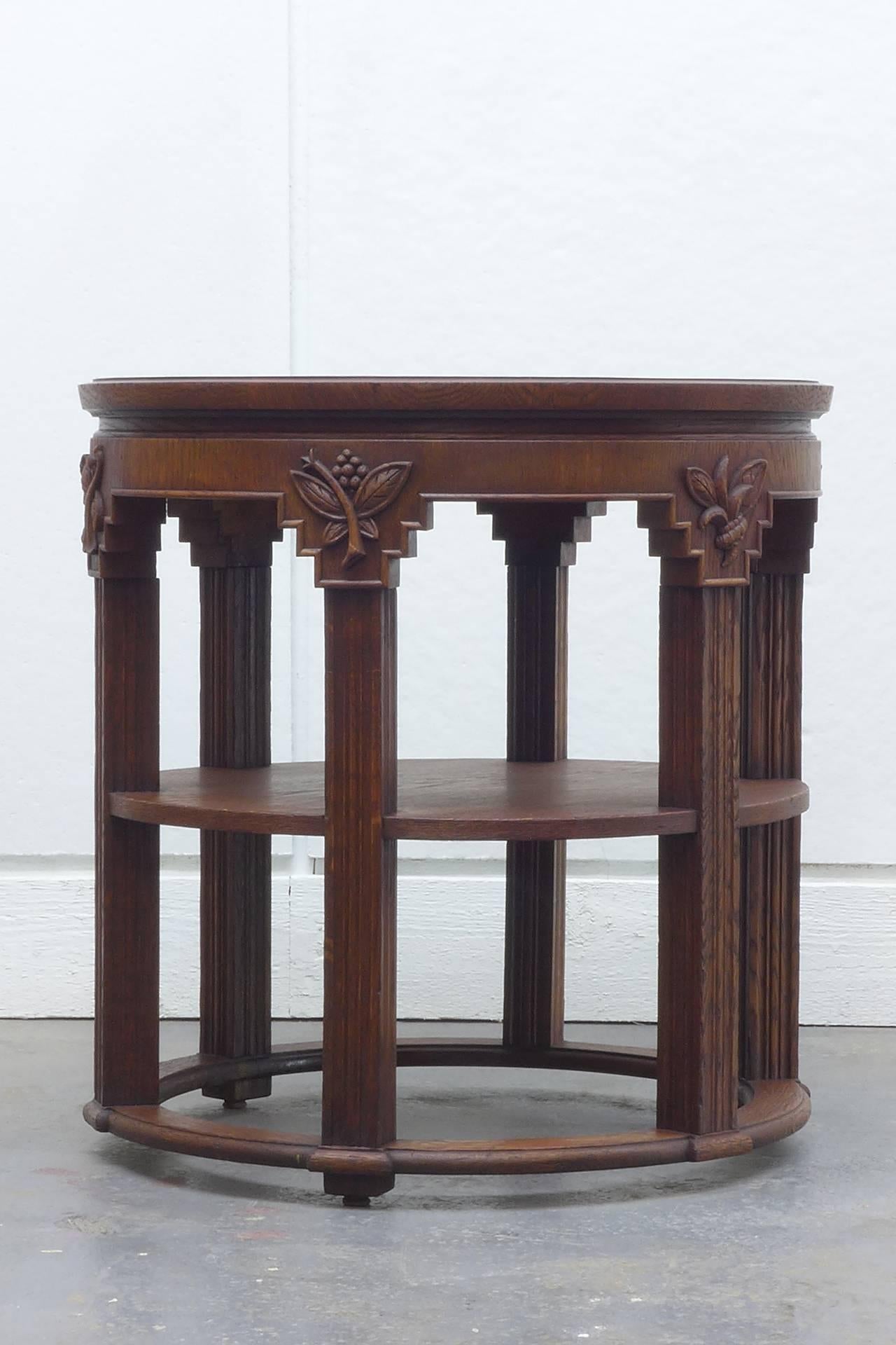 German expressionist oak side table. The two tiers resting on six fluted legs.