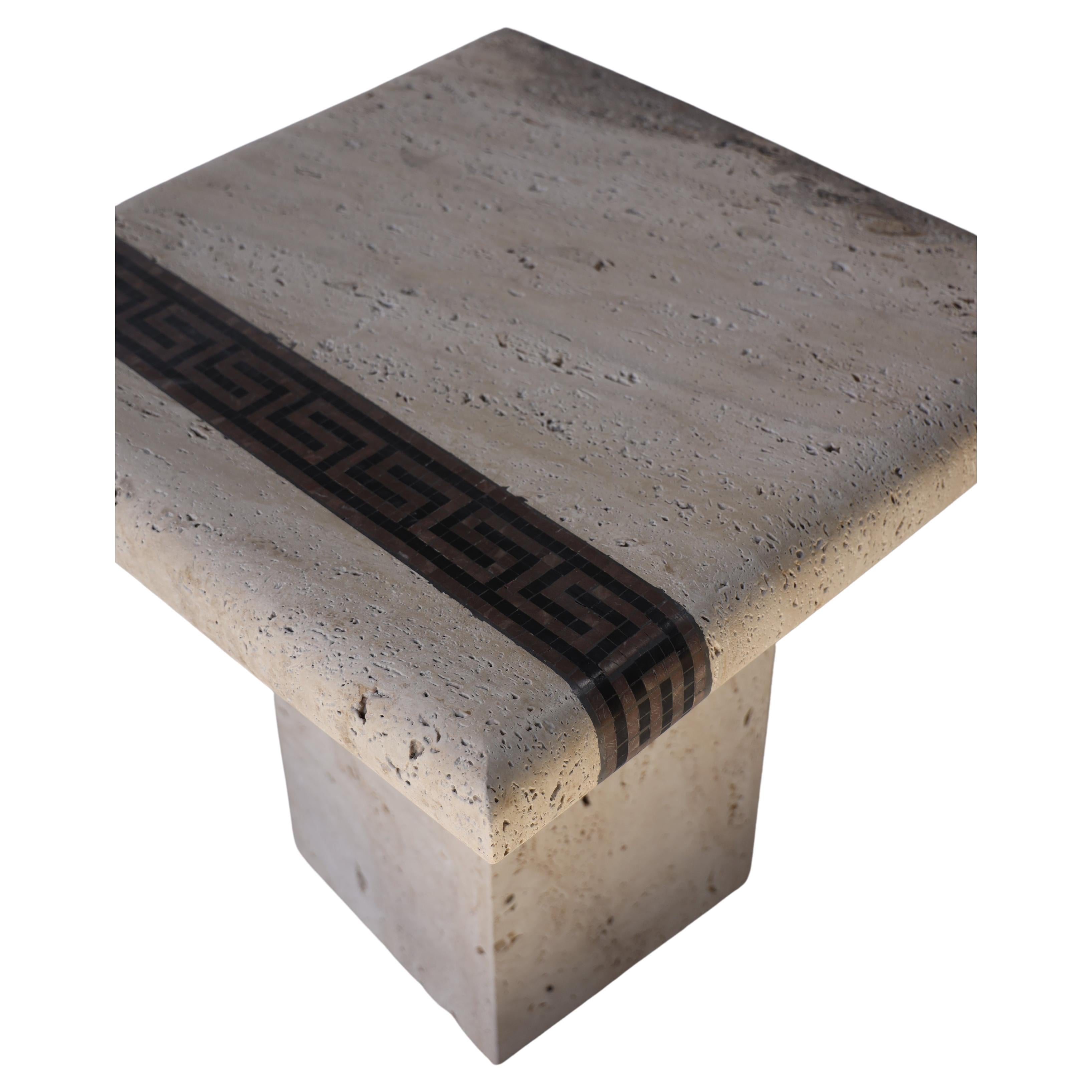 Introducing a stunning coffee table that effortlessly blends elegance and natural beauty made of Ascolane Travertine and detailed with a line of marble mosaic. This exquisite piece of furniture is meticulously crafted to create a captivating focal