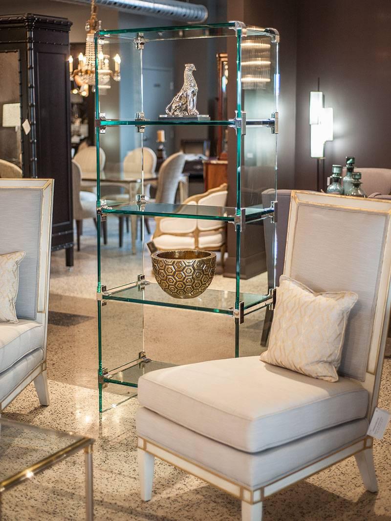 Stunning glass étagère constructed with thick glass panels and stainless steel corner brackets. Very heavy, solid build with five shelves for display. 