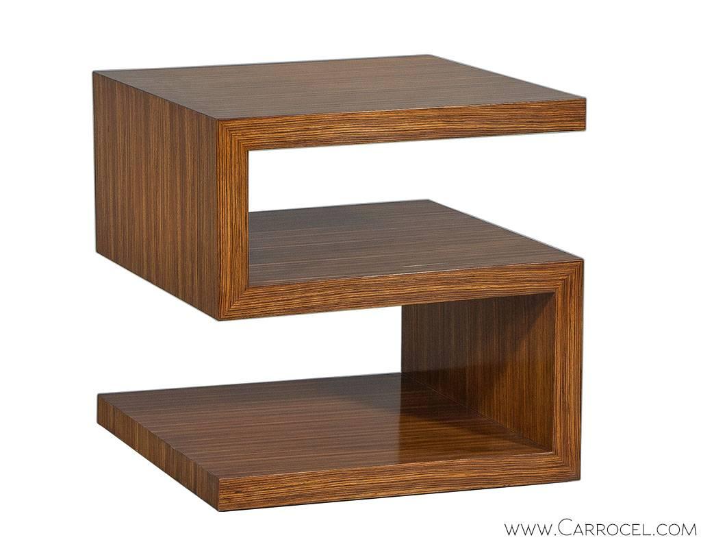 Made by EJ Victor, designed by Allison Paladino, this zebrawood end table is constructed with quality and style. The boxy s-shape design creates multiple layers of shelving for storing and displaying mementos and the look is further modernized with