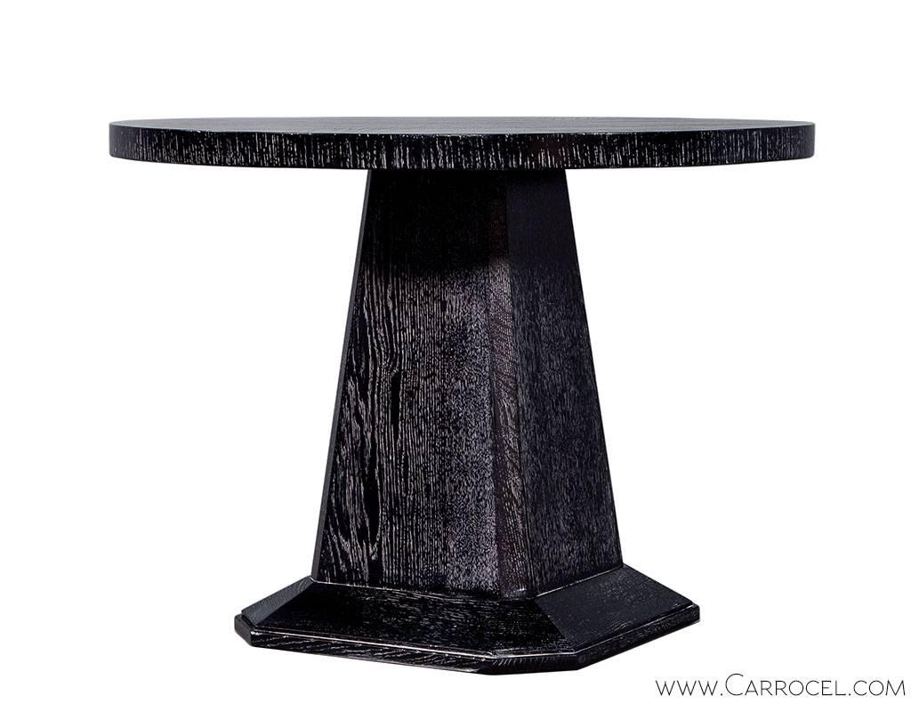 Beautiful antique occasional table enveloped in a new gorgeous coat of our custom Obsidian cerused finish. The round top is veneered in a starburst pattern and rests on a square chamfered pedestal. A stunning antique appealing to modern taste.