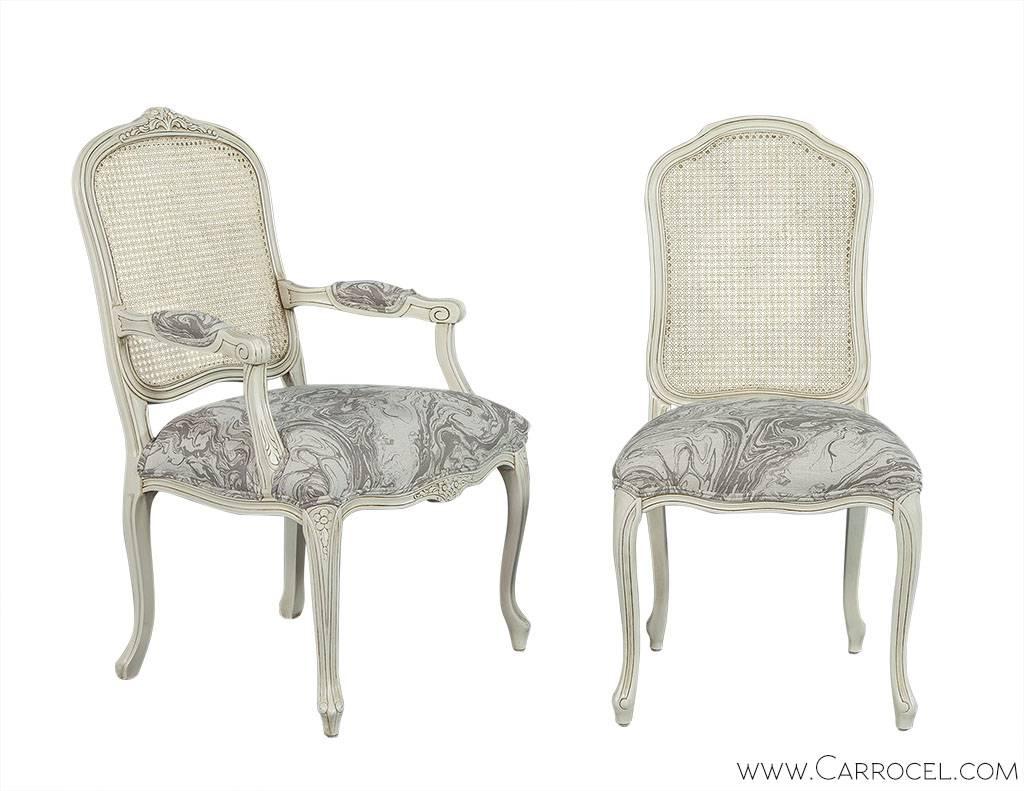 Classic Louis XV style custom dining chair made from European beechwood. Designed with a scalloped frieze embellished in floral motifs on the arm chairs, curved cabriole legs with an escargot foot detail and a straight back pitch to enhance good
