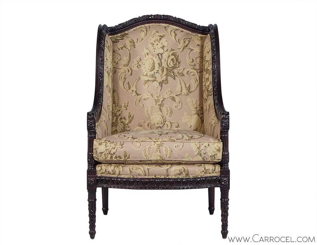 This beautiful antique themed chair has an intricately carved mahogany frame with a satin finish. The cushions are a light mauve and pale yellow floral print and it has a loose box seat. Turned and fluted legs complete the look and add even more