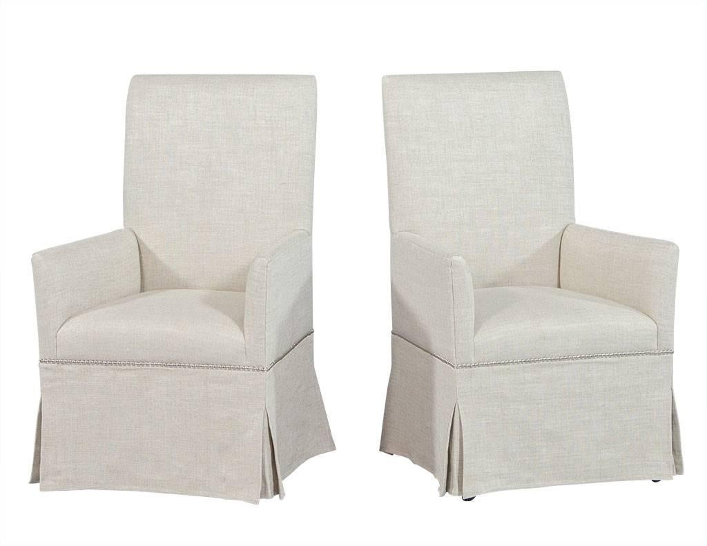 Stylish and comfortable, the salon dining chair is fully upholstered in lush white Belgian linen with a floor length skirt, accented by head-to-head nail trim around the base of the seat. Designed with a modern appeal the chair has a square back and