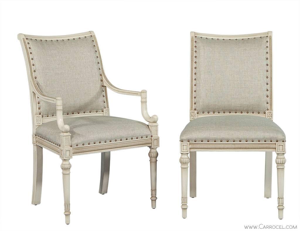 This set of eight chairs has intricately carved frames with perfectly detailed front legs. These new age dining chairs have light shimmery upholstery with spaced out nail trim around the edges. They have been carved out of beechwood in a