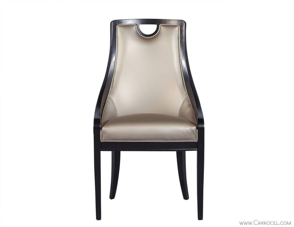 These quirky dining chairs consist of maple framing in a satin black finish. They are topped with pewter vinyl and boast a spiral motif fabric on the outside back. The handle top lends stylistic flair as well as utility and establishes this chair as
