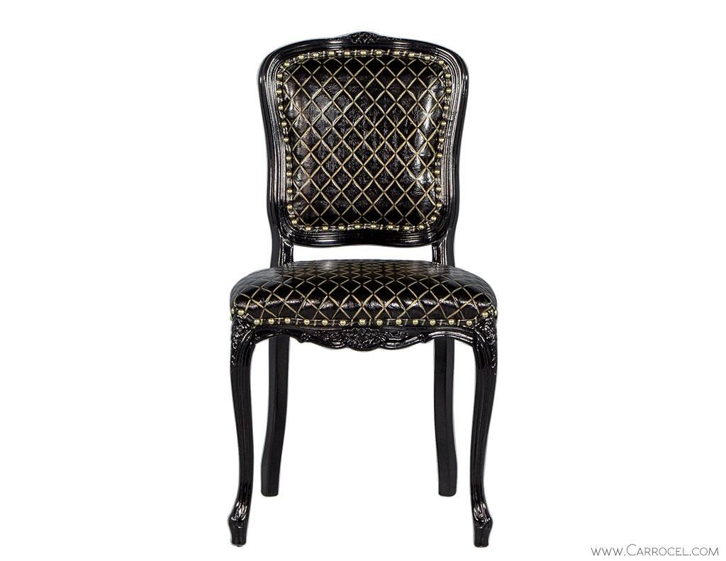 Dainty Louis XV style dining chair with small floral carved details. Made from Italian beechwood with a thin show wood frame and curved cabriole leg. This frame has been finished in Carrocel custom Obsidian Black and upholstered in embossed black
