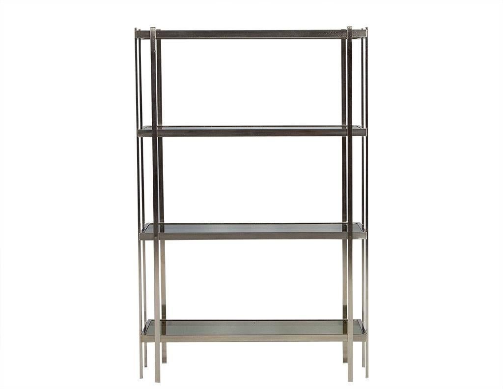 Mid-Century Modern brushed nickel étagère with smoked glass shelves.