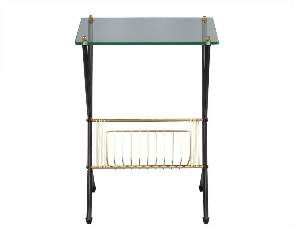 This Italian designed and manufactured magazine stand boasts black iron angled legs, a curved brass storage tray and a sharp glass top. Not only is this piece functional in any living room, the mixed materials make a real fashion statement – just
