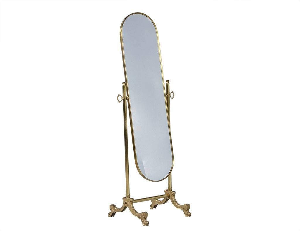 This stunning race-track oval mirror is edged with a thin, brass frame and mounted on a heavy brass stand. It truly is an elegant and timeless piece that will lend lavish, French flare to any bedroom or walk-in closet.