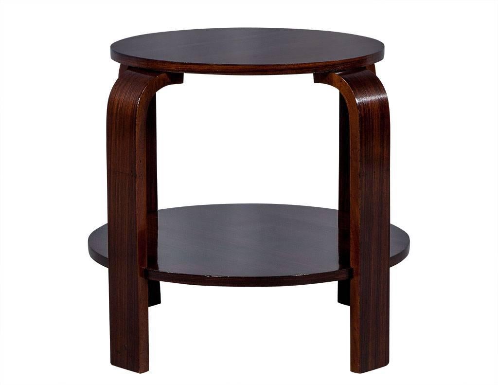 This richly finished, Art Deco side table is made of solid wood with a lower shelf and curved legs. French in design and the perfect addition to any bedroom or living area.